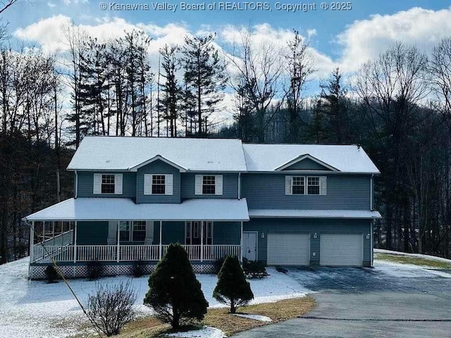 view of front of home featuring covered porch, aphalt driveway, and an attached garage