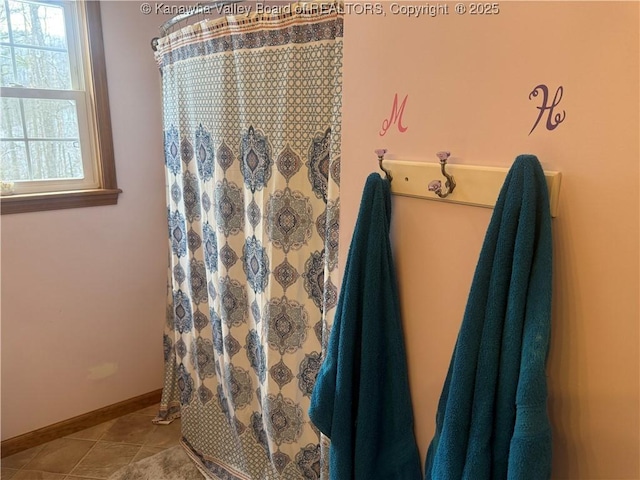 bathroom featuring baseboards and tile patterned floors