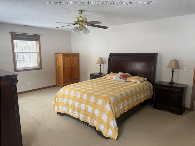 bedroom featuring light carpet, ceiling fan, a textured ceiling, and baseboards