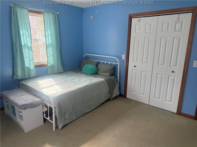 bedroom featuring a closet and light colored carpet