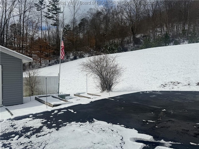 yard covered in snow with fence