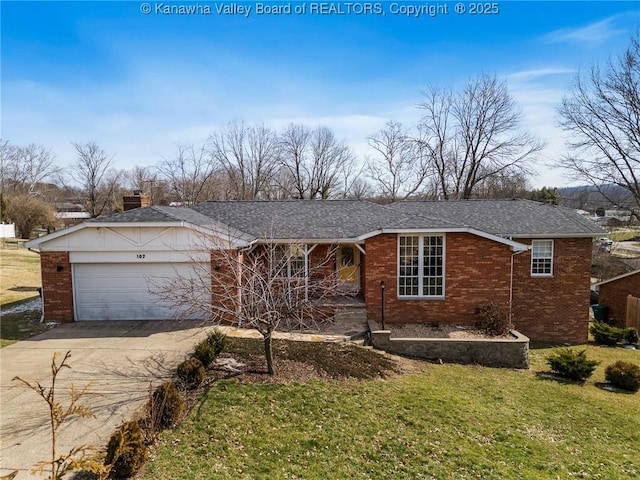 view of front of home featuring an attached garage, brick siding, concrete driveway, and a front yard