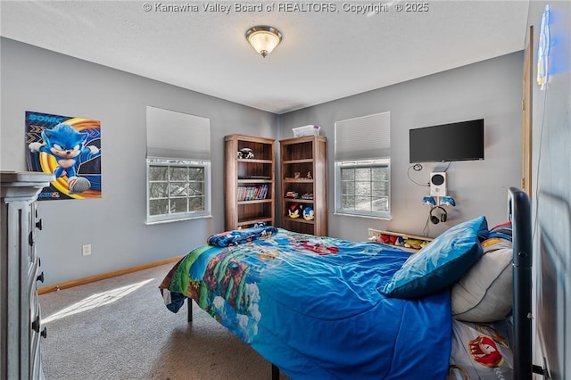 carpeted bedroom featuring baseboards