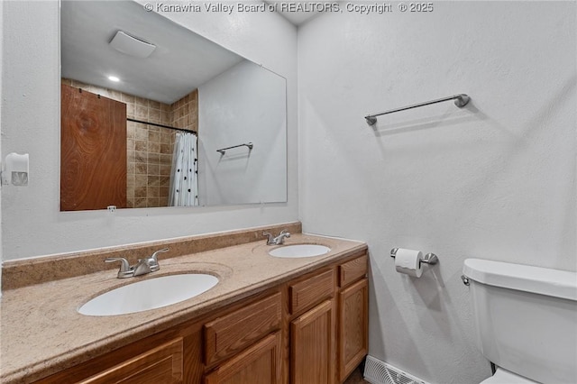 full bathroom with toilet, double vanity, a sink, and a shower with shower curtain