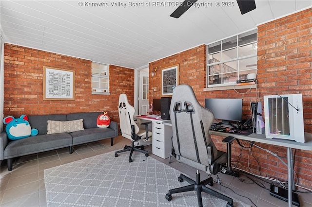 home office with brick wall and light tile patterned floors