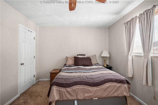 bedroom featuring light colored carpet and baseboards