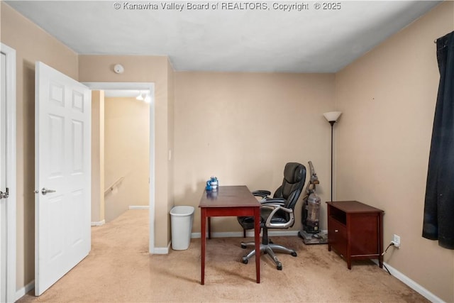 office area featuring light colored carpet and baseboards