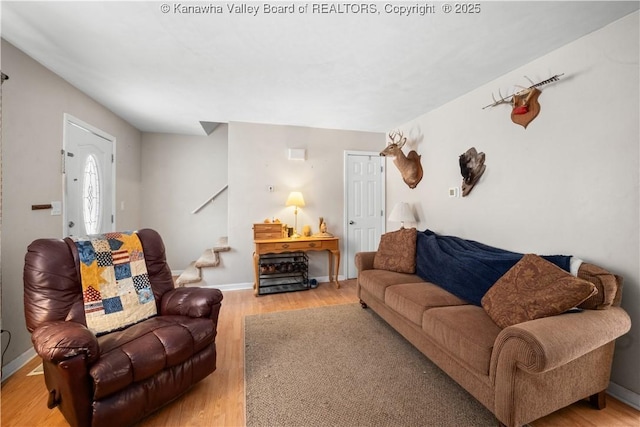 living room with baseboards and light wood-style floors