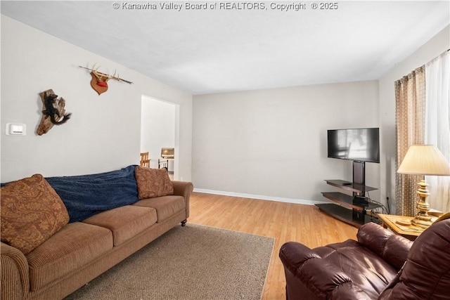 living area with wood finished floors and baseboards