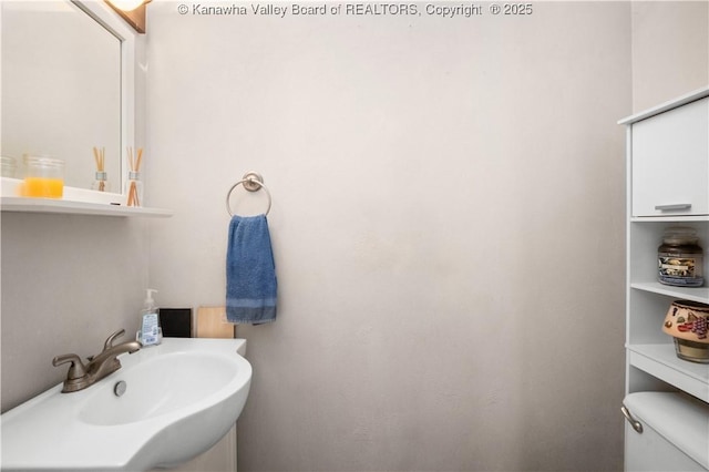 bathroom featuring toilet and a sink