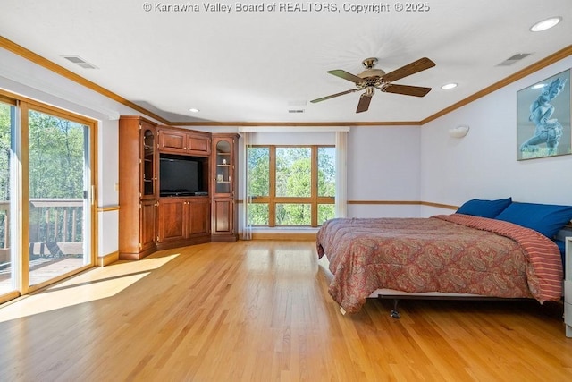 bedroom with light wood-style flooring, multiple windows, visible vents, and crown molding