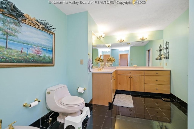 full bathroom with vanity, toilet, and tile patterned floors