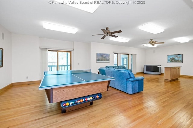 recreation room featuring light wood-style flooring, baseboards, and a ceiling fan