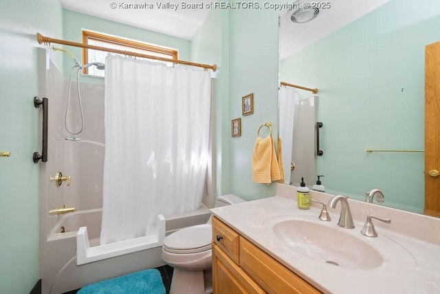 bathroom featuring toilet, shower / bath combo with shower curtain, and vanity