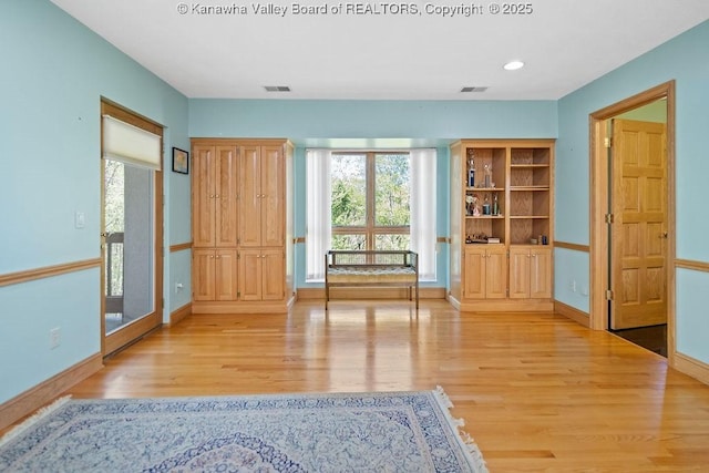 interior space with light wood-style flooring, visible vents, baseboards, and recessed lighting