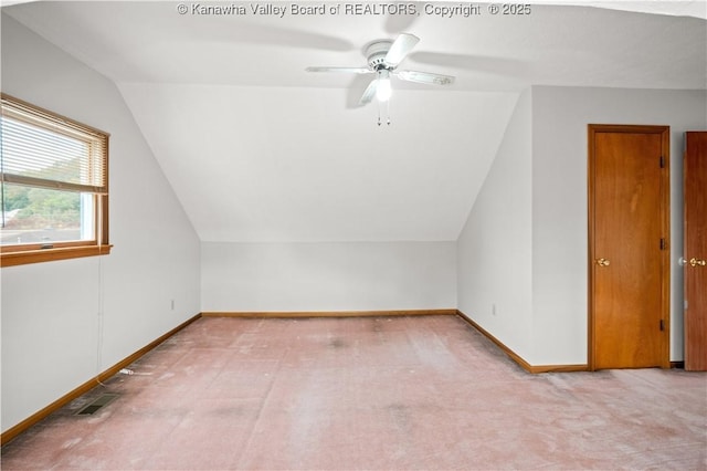 bonus room featuring lofted ceiling, visible vents, baseboards, and light colored carpet