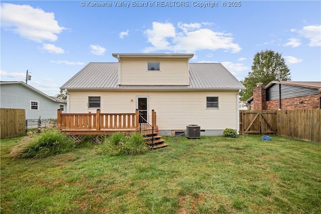 back of property with a gate, a fenced backyard, a lawn, and a deck