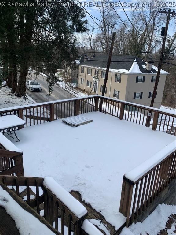 snowy yard featuring a deck