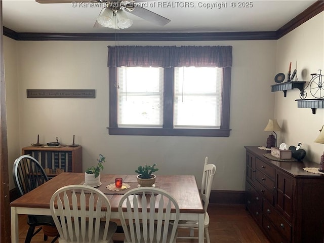 dining space featuring a healthy amount of sunlight, baseboards, a ceiling fan, and crown molding