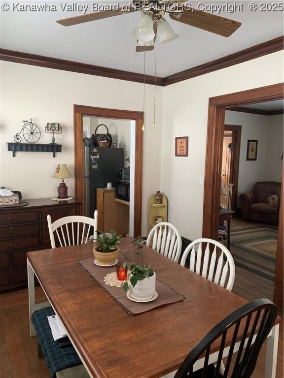 dining space featuring ornamental molding, dark wood-style floors, and a ceiling fan