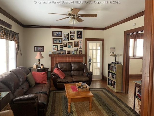 living area with plenty of natural light, crown molding, and wood finished floors