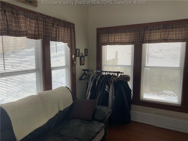 interior space with radiator heating unit and wood finished floors