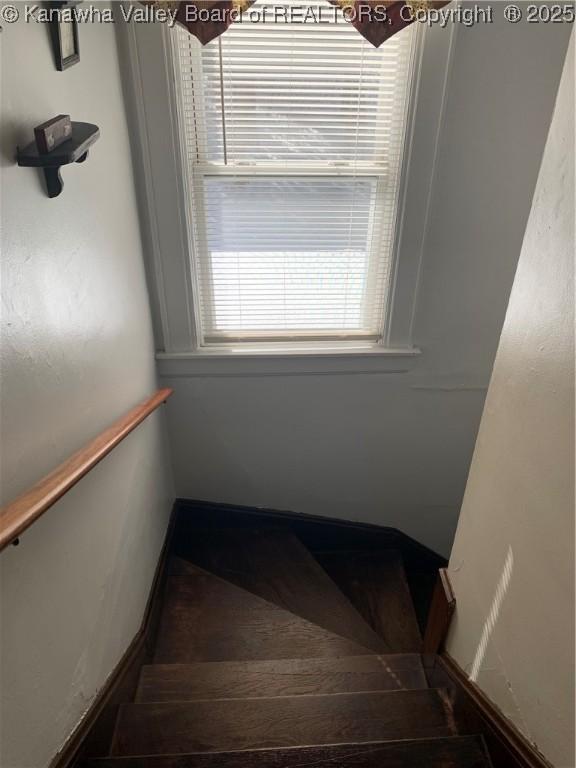 stairway featuring baseboards