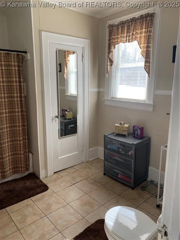 doorway to outside with light tile patterned floors and baseboards