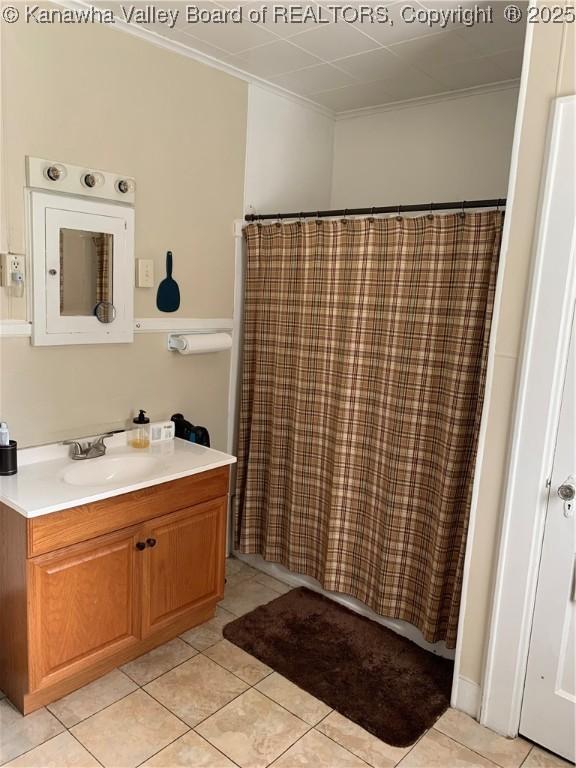 bathroom featuring ornamental molding, tile patterned flooring, and vanity