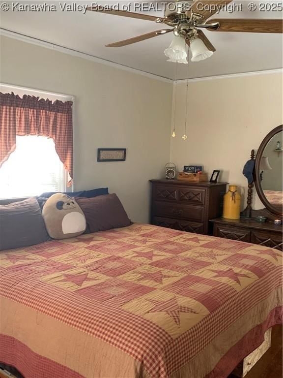 bedroom with a ceiling fan and crown molding