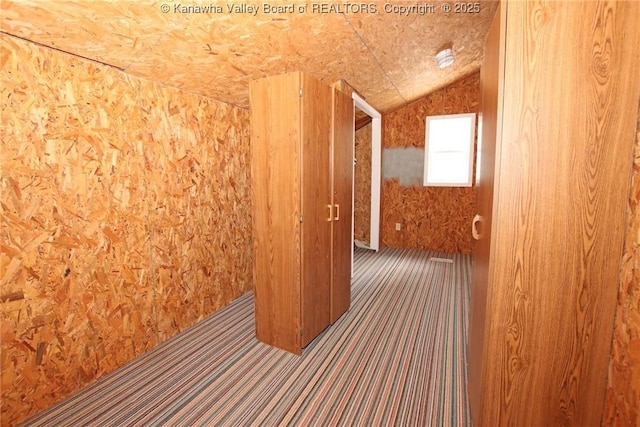 hallway featuring lofted ceiling