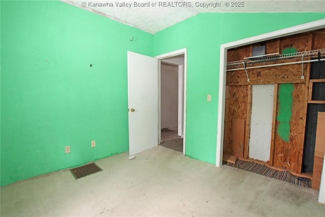 unfurnished bedroom featuring vaulted ceiling and a closet