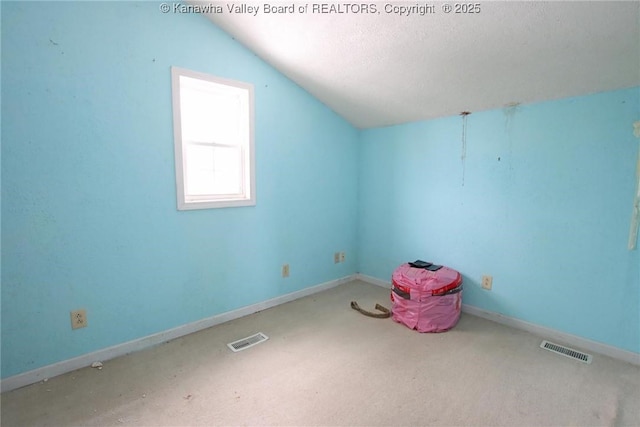 bonus room featuring baseboards, visible vents, and vaulted ceiling