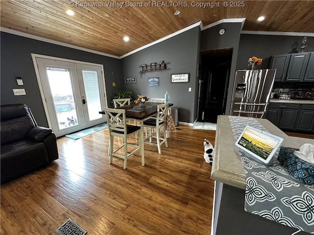 dining room with ornamental molding, french doors, vaulted ceiling, and wooden ceiling