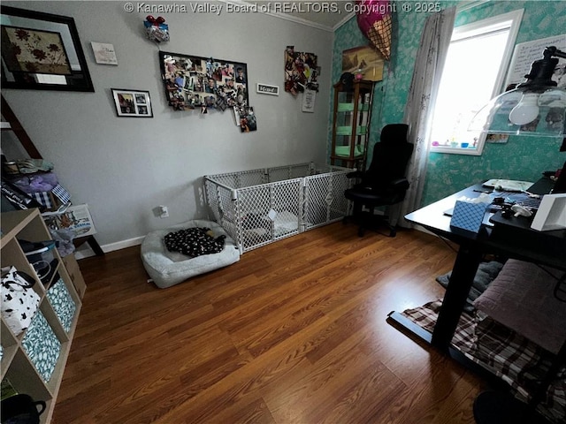 office area featuring baseboards, wood finished floors, and crown molding