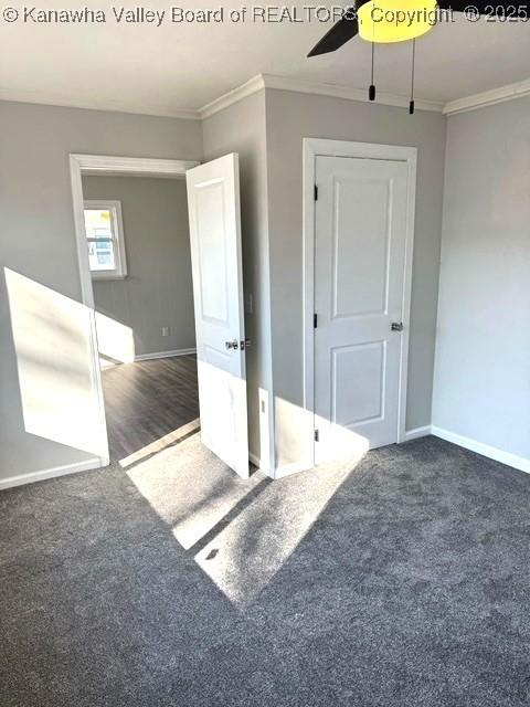 unfurnished bedroom with carpet flooring, baseboards, and ornamental molding