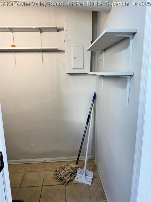 walk in closet with tile patterned flooring