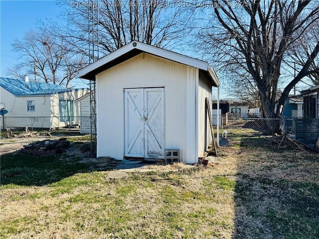 view of shed featuring fence