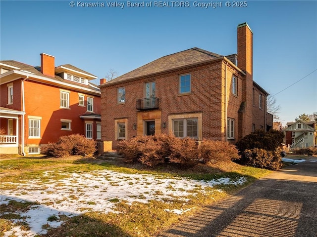 exterior space featuring a chimney and brick siding