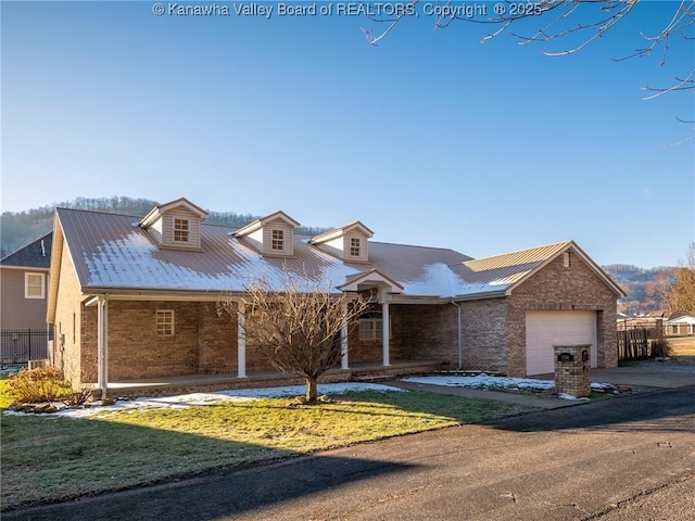 view of front of home with an attached garage, a front yard, concrete driveway, and brick siding