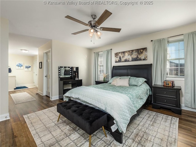 bedroom featuring a ceiling fan, baseboards, and dark wood-type flooring