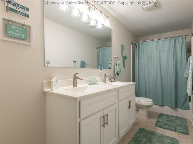 full bathroom with tile patterned flooring, visible vents, shower / bath combo with shower curtain, and a sink