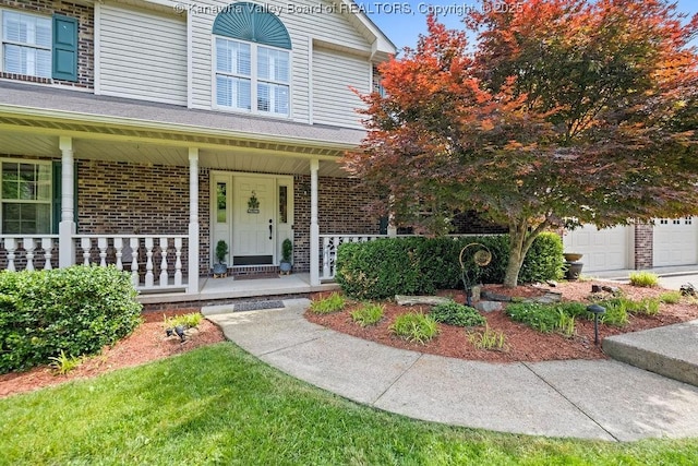 view of front of home featuring covered porch and brick siding