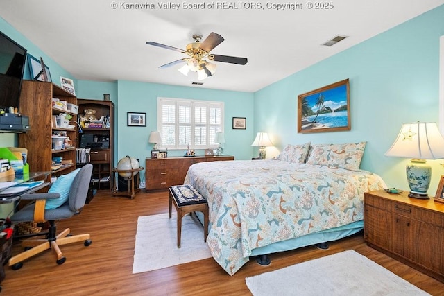 bedroom with wood finished floors and visible vents