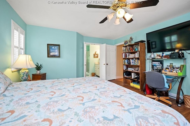 bedroom with a ceiling fan, ensuite bathroom, and wood finished floors