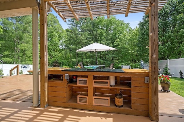 exterior space with a deck, outdoor dining area, fence, and a pergola