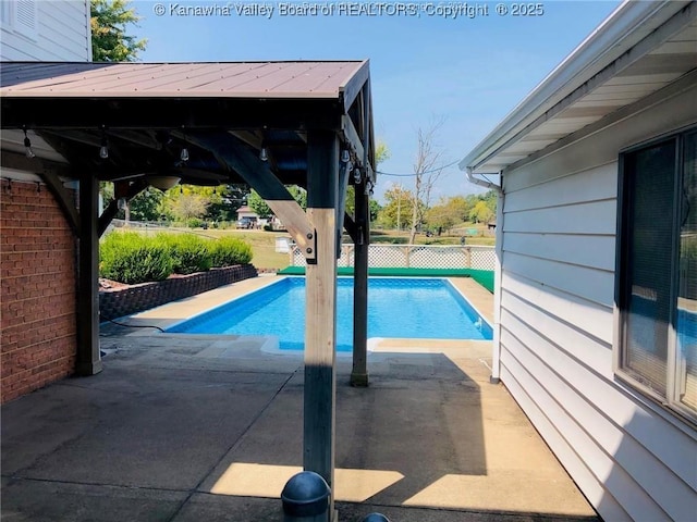 view of swimming pool featuring a fenced in pool, fence, a patio, and a gazebo