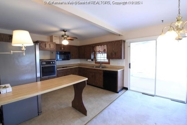 kitchen with dark brown cabinetry, a sink, light countertops, hanging light fixtures, and black appliances