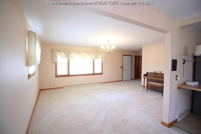 interior space with baseboards, visible vents, and a notable chandelier