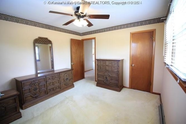 bedroom featuring ceiling fan and light carpet